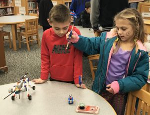 two students working with LEGO