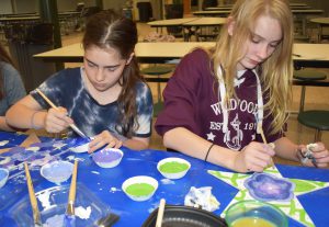 students painting stars