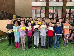 group photo of 1st grade students holding certificates