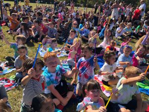 kids with pinwheels at outdoor assembly