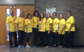 teachers wearing gold shirts