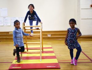 three girls playing in gym class