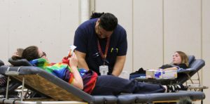 technician assisting someone donating blood