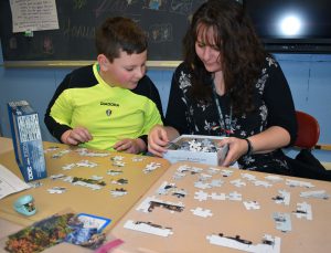 student and mom making a puzzle