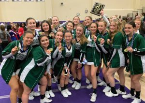 Varsity cheer team with Section IX plaque