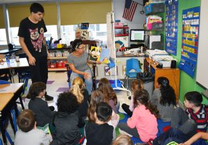 high school students reading to little students
