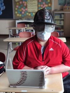 student wearing fire hat