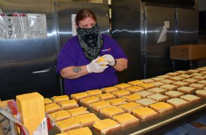 food service worker preparing sandwiches