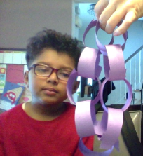 student with paper chains