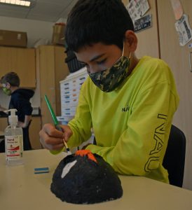 student painting mask