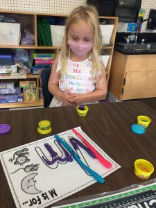 student with Play Doh