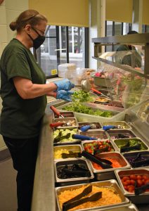 food service worker with salad buffet