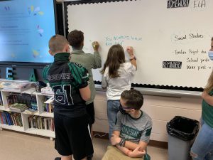 students writing on board