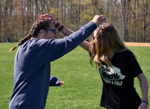 students cracking eggs on their heads