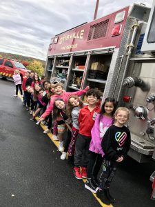 students in front of fire truck