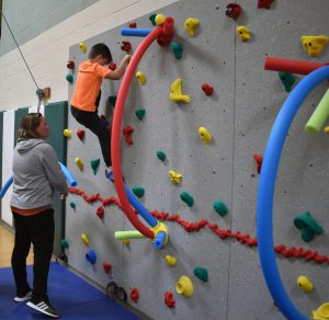 student climbing wall