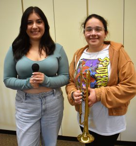 two students with instrument and microphone