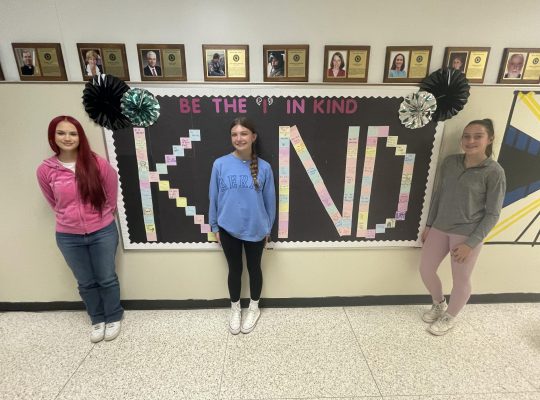 students with KIND sign