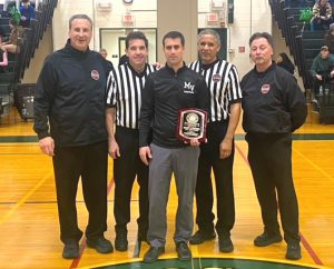 Coach Caputo with officials and award