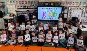 students with kindness signs